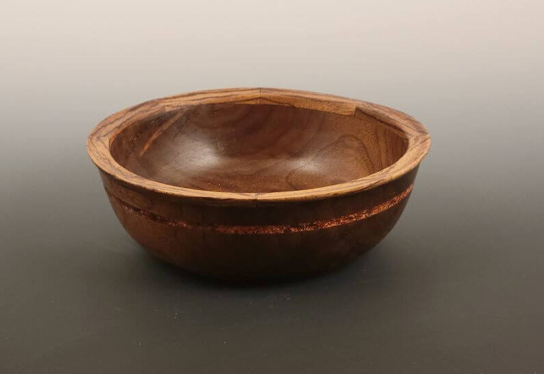 Walnut bowl with inlay ring and segmented edge